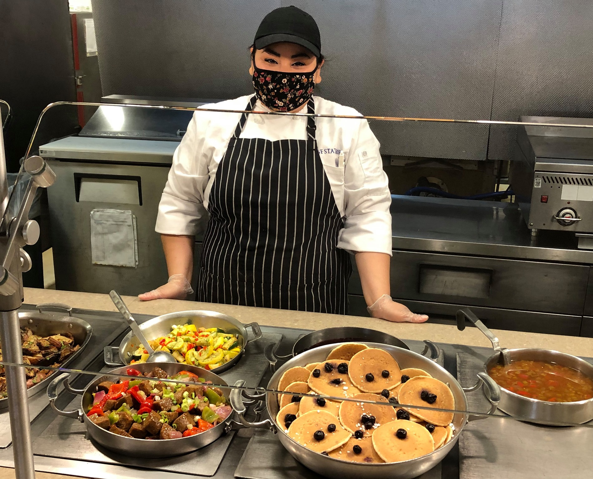 Dining employee at food station