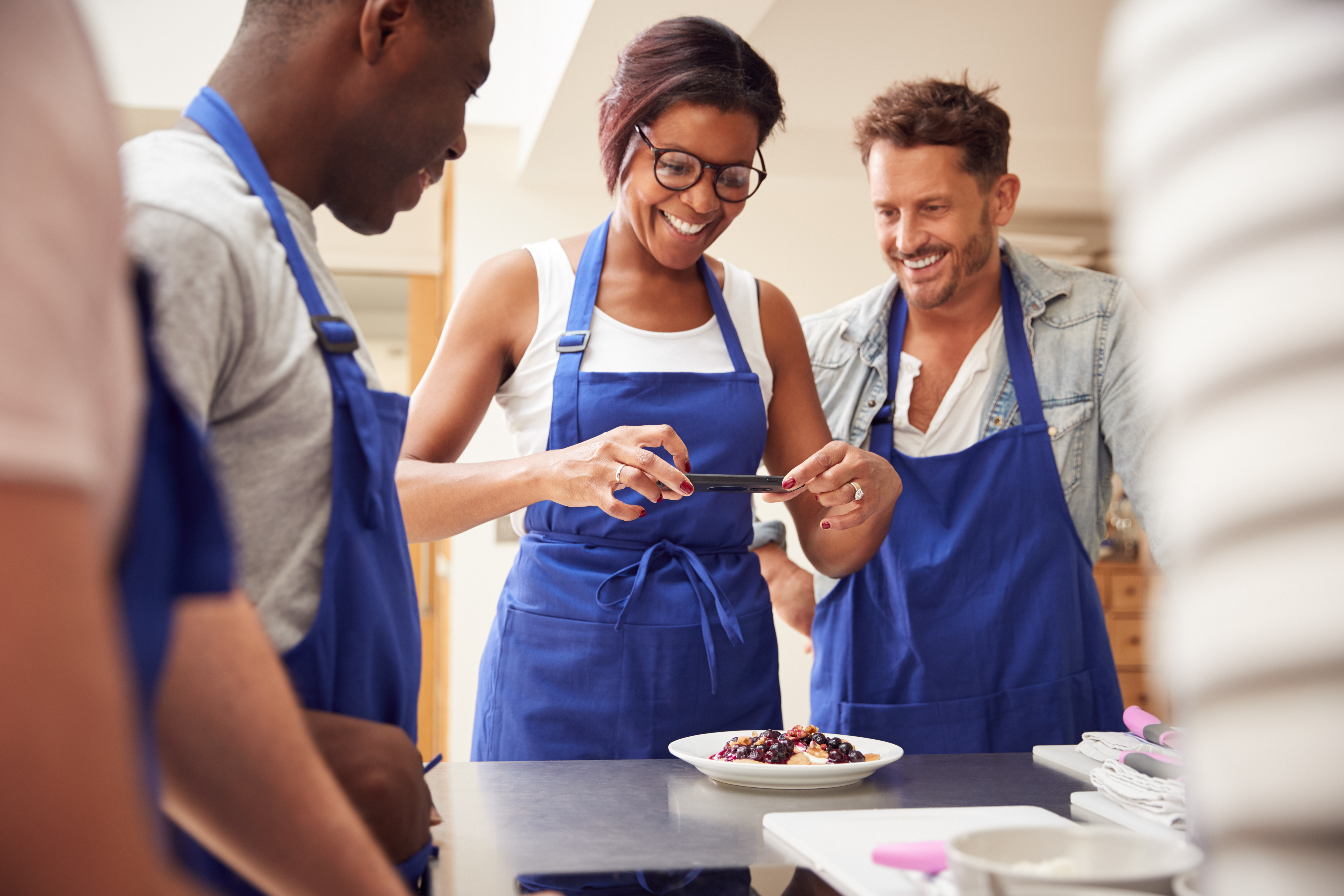 Student taking photo of food at a cooking class