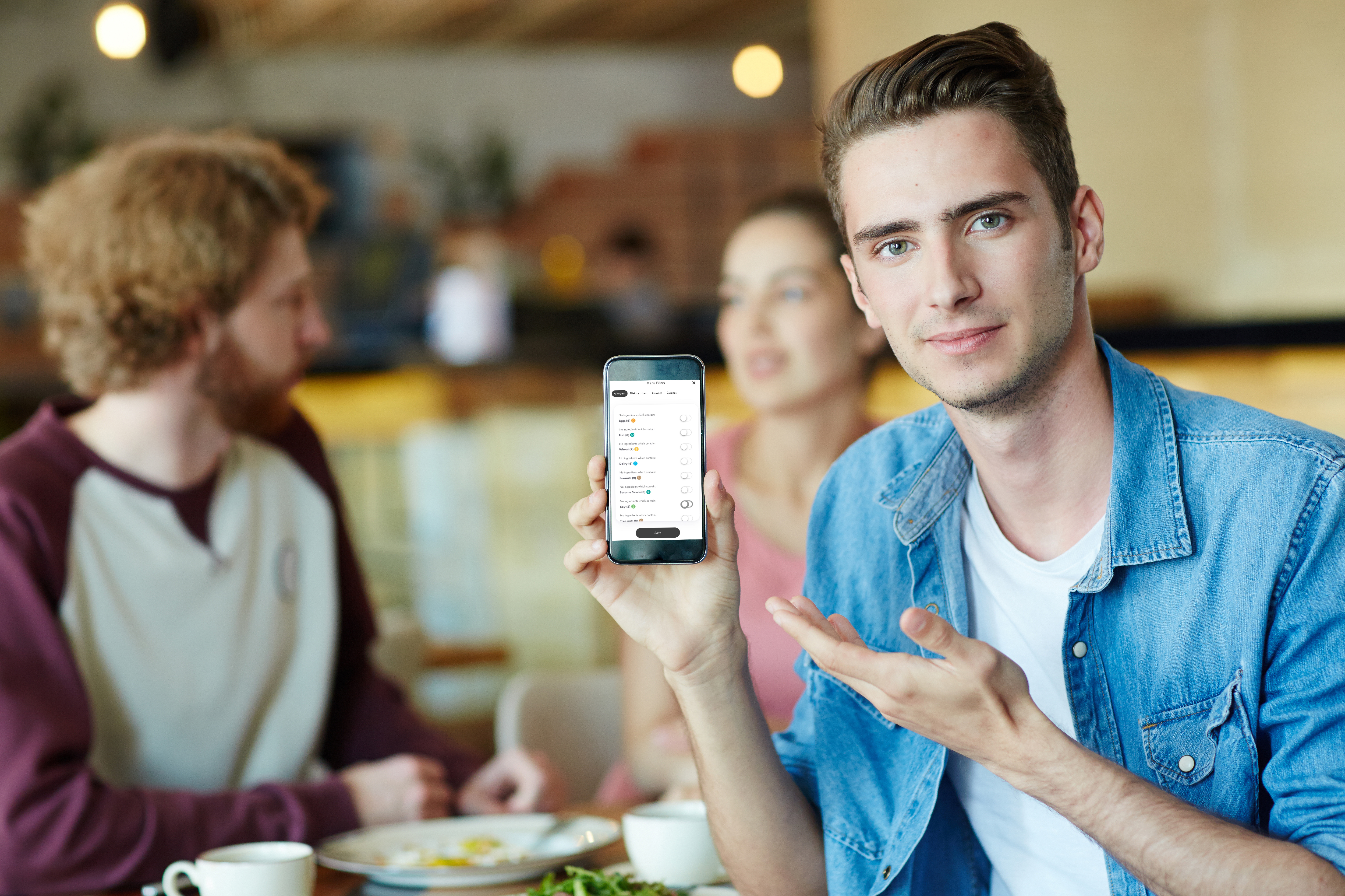 Student holding up phone at dining center