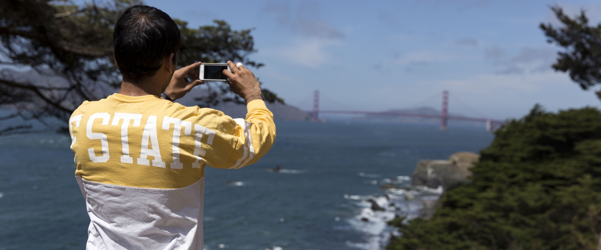 Student taking photo of the Golden Gate Bridge