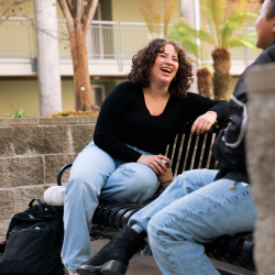 Students sitting and laughing in the housing community