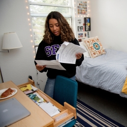 Student reviewing housing document