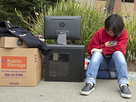 student sitting with belongings