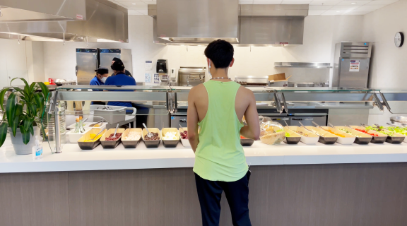 Student looking at food options at dining center