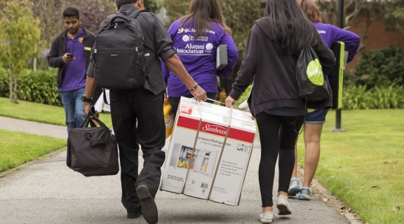 Students walking with boxes on Move-in day